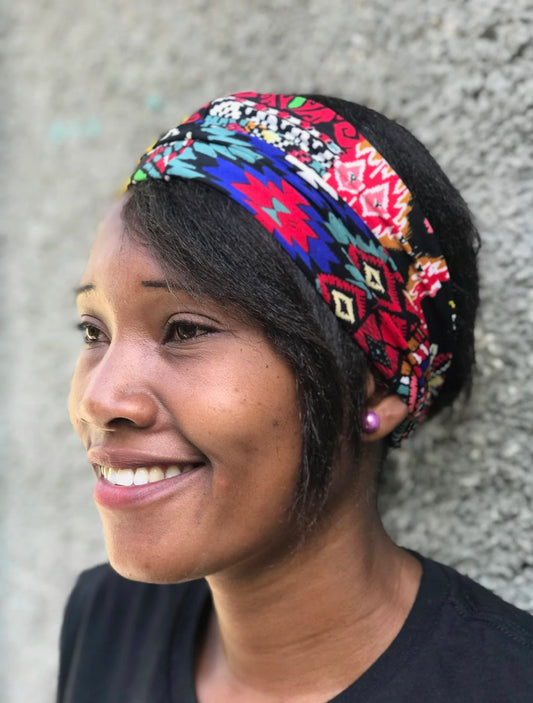 Haitian Artisan wearing Handcrafted Headband produced by Papillon Enterprises in Haiti.  Accesorize your look with these headbands that come in colorful or muted tones. 