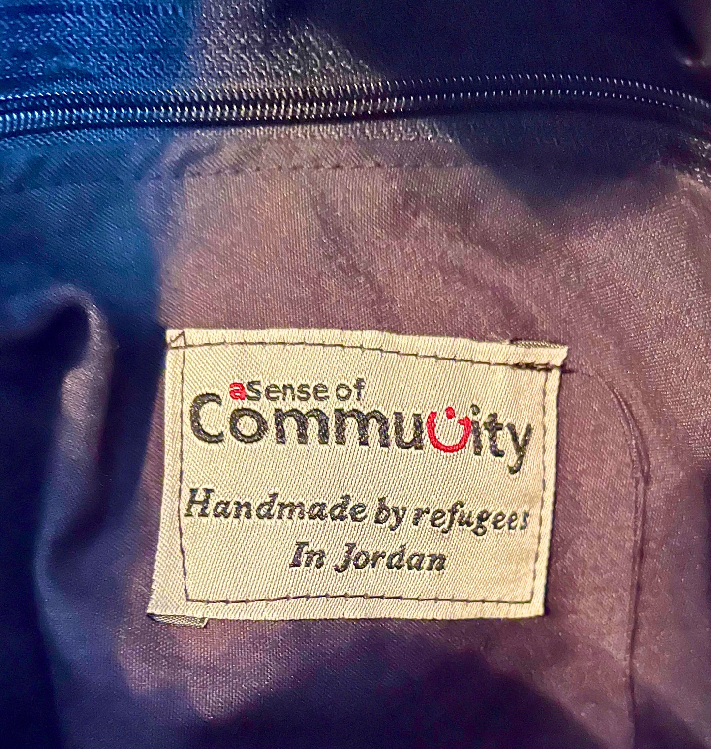 Finished with a hand stitched tag from "a Sense of Community", part of the Nün Project.  Handmade by refugees in Jordan. 