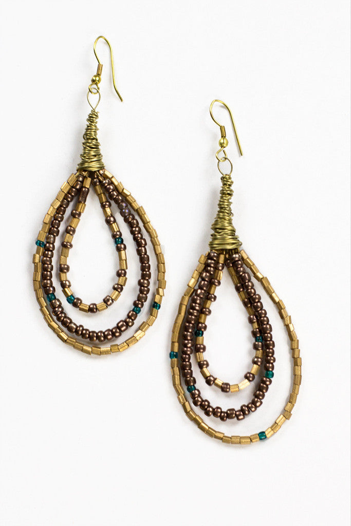 Close-up photo of Grecian Goddess Earrings in bronze, teal, and chocolate brown. Handmade in India, these earrings feature an intricate design with a combination of small and large beads. The earrings hang from a fishhook wire and are the perfect statement accessory for any outfit.