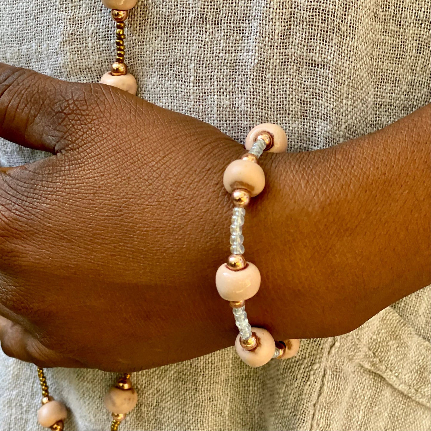 A sweet classic piece with subtle ceramic beads in loving memory of Marise and her baby. The ceramic beads represent Marise and the work she did making beads. The rose gold beads represent her baby who went to Heaven with her. The white seed beads represent the five children she left behind. 