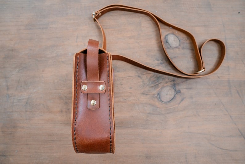 Photo of the Leather Crossbody Purse, showcasing the premium quality leather and artisanal detailing handcrafted by skilled artisans in India. The classic crossbody design ensures comfortable wear. The photo shows the purse with a focus on the unique detailing and the versatile design that makes it perfect for any occasion.
